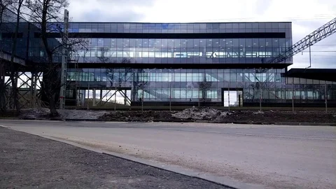 A passing train on the background of the glass station building Stock Footage 106664891