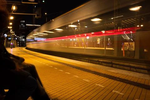 Passing train leaving light trail in the train station Stock Photos