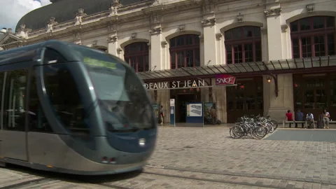 Passing Tram Reveals the Facade of The St. Jean Gare De Bordeaux Train Station Stock Footage 173574145