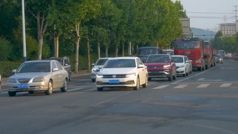 Passing vehicles at a traffic light intersection Stock Footage 158718537