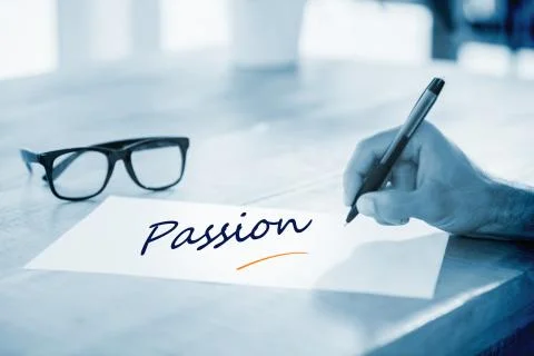 Passion  against side view of hand writing on white page on working desk Stock Illustration