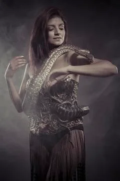 Passion, brunette woman posing with a python snake australian Stock Photos