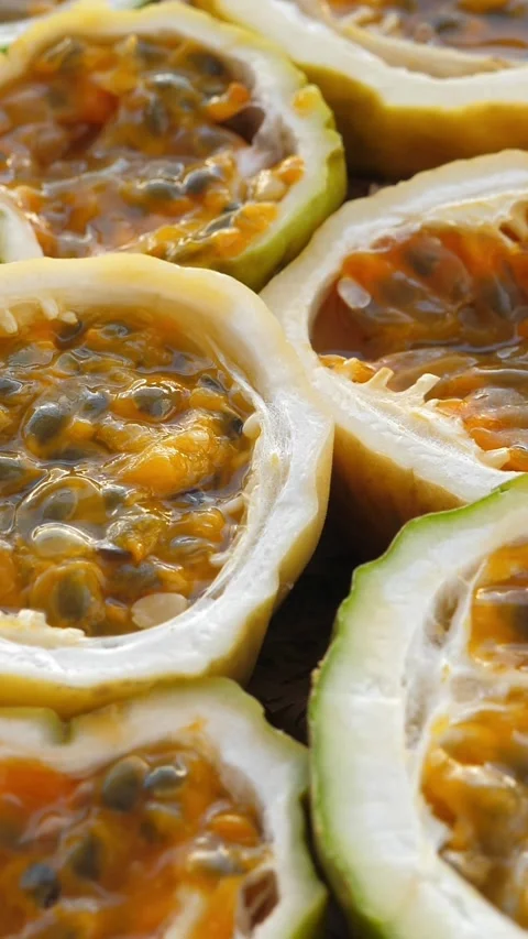 Passion fruit background with half cut chinola. A lot of sliced maracuja Stock Footage 327096753