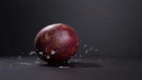 Passion fruit drop with water splash in slow motion on black background Stock-Footage 142774673