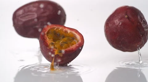 Passion fruit falling and bouncing on water surface. Slow Motion. Stock Footage 50513675