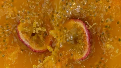 Passion fruit falling into juice Stock Footage 205319643