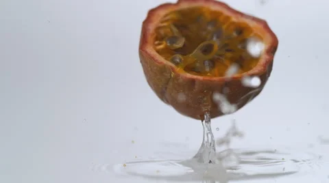 Passion fruit falling on water surface. Slow Motion. Stock Footage 55880051