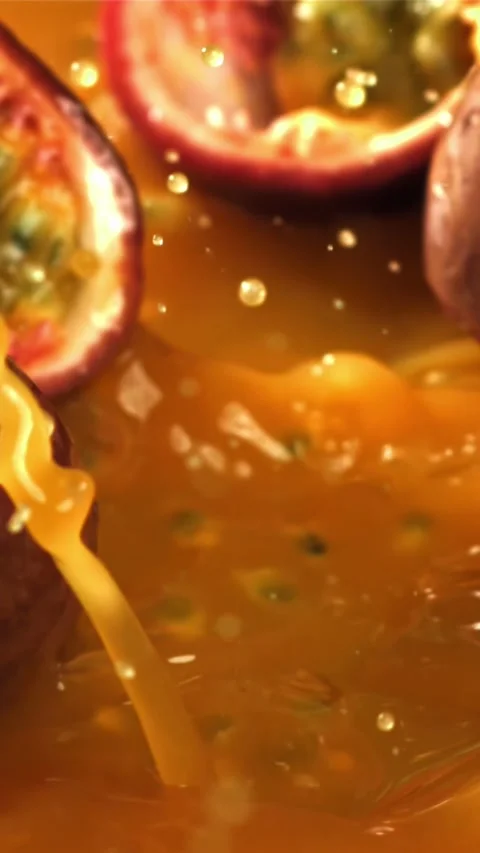Passion fruit falls into the juice with splashes. Filmed on a high-speed camera Stock Footage 335316232