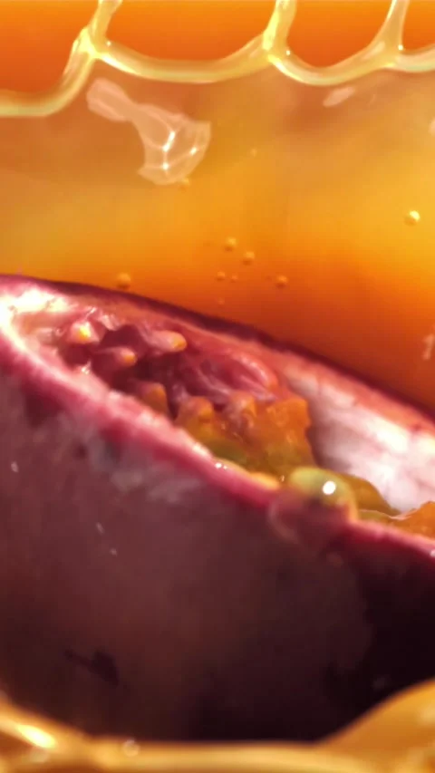 Passion fruit falls into the juice with splashes. Filmed on a high-speed camera Stock Footage 335323720