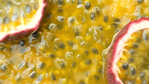 Passion fruit halves rotating slowly over background of juicy pulp, copy space f Stock Footage 344289008