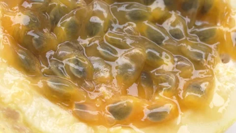 Passion Fruit Interior in Extreme Close Up Showing Juicy Golden Pulp 4K 動画素材 348218132