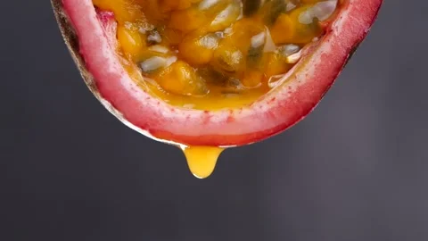 Passion fruit juice drop from half passion fruit in slow motion Stock-Footage 142914991