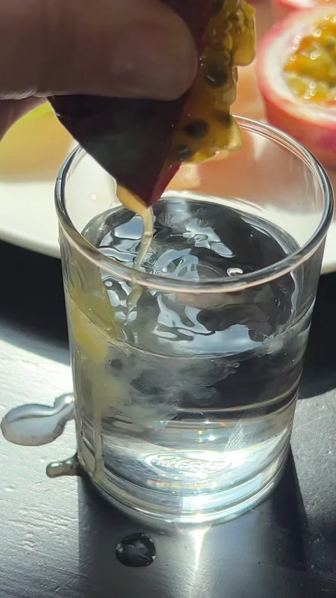Passion fruit juice Pouring a passion fruit cocktail with a cocktail shaker Stock Footage 322098544