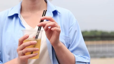 Passion fruit lemonade. Summer drink in the hands of a girl. Takeaway lemonade Video stock 244319441