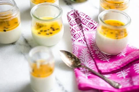 Passion fruit panna cotta on tiny glasses and pink napkin Foto stock