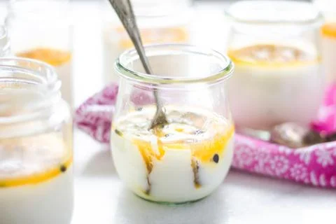 Passion fruit panna cotta on tiny glasses and pink napkin Stock Photos