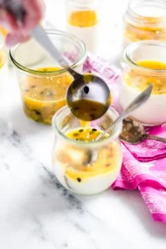 Passion fruit panna cotta on tiny glasses and pink napkin Stock Photos