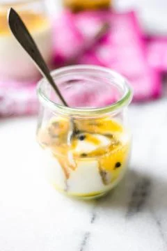 Passion fruit panna cotta on tiny glasses and pink napkin Stock Photos