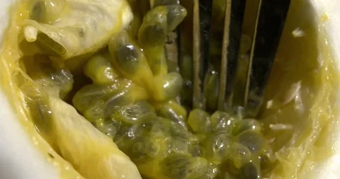 Passion fruit pulp being stirred with a fork, slow motion Video stock 301017264