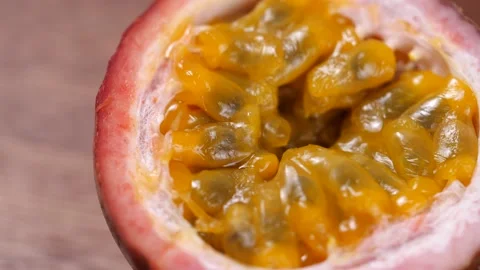 Passion Fruit rotate in slow motion on a wooden table Stock Footage 142914958