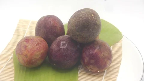 Passion fruit rotating on white background Stock Footage 118773601