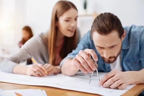 Passionate admirable engineer adding new elements carefully Stock Photos