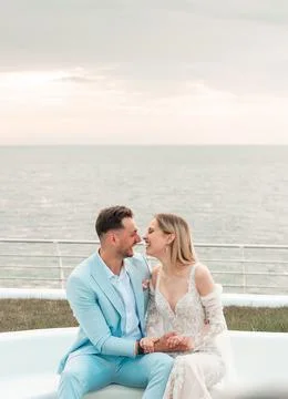 Passionate bride and groom on their wedding on tha background of the sea Stock Photos