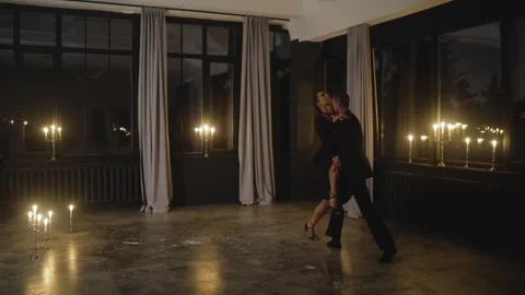 Passionate couple performing tango in candlelit studio Stock Footage 314623654