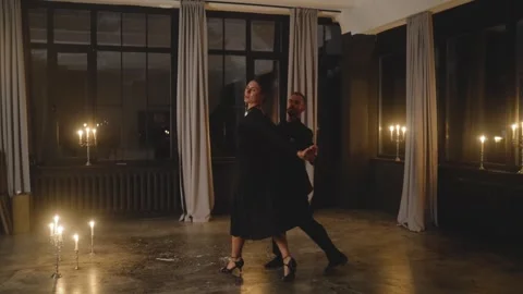 Passionate dancers performing tango in candlelit studio Stock Footage 301560428