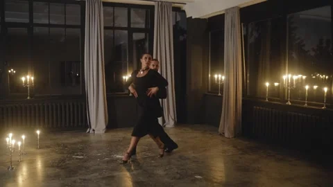 Passionate dancers performing tango in candlelit studio Stock Footage 301560484