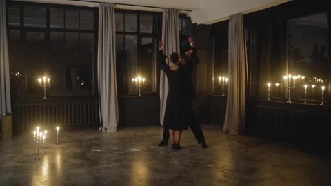 Passionate dancers performing tango in candlelit studio Stock Footage 301560546