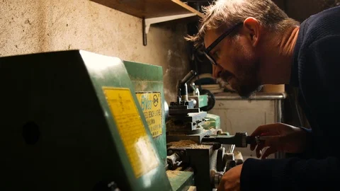 Passionate DIY man, he uses the lathe for DIY, in his home laboratory, precision Stock-Footage 101007480