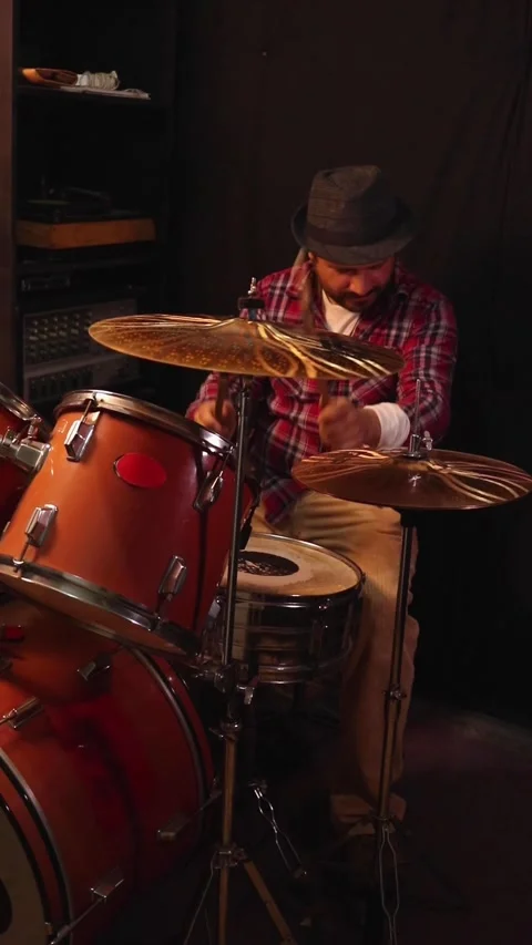 A passionate man plays a drum roll on an acoustic drum set 動画素材 345089237