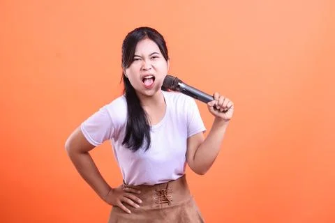 Passionate singer with a microphone Stock Photos