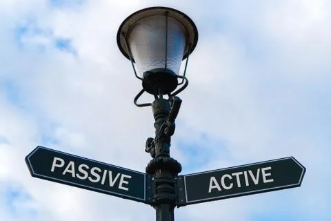 Passive versus Active directional signs on guidepost Stock Photos
