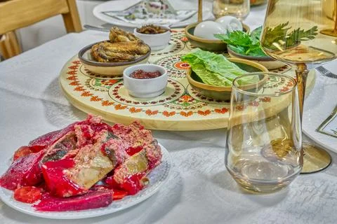Passover dinner table arranged with matzah, symbolic greens, and a decorated  Stock Photos