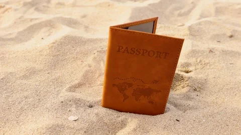 Passport falling on the sand of the sea Video stock 286343214