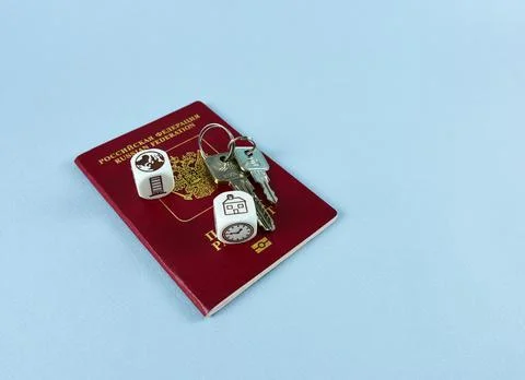 Passport, keys, cubes with the image of the planet and the house. Stock Photos