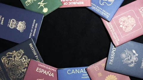 Passport of multiple nationalities placed in circle  with black copy space Stock Footage 297518255
