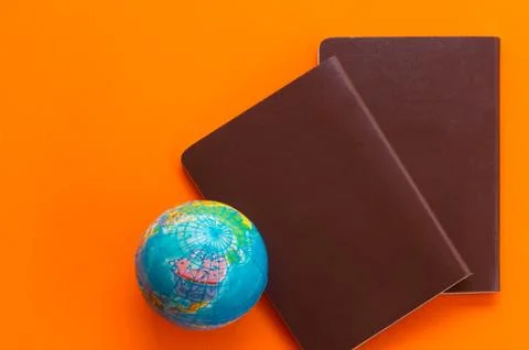 Passport on orange background Stock Photos