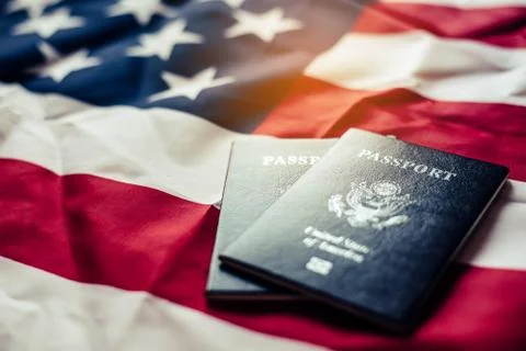 Passport is placed on the US flag. Preparing for a legitimate journey Stock Photos