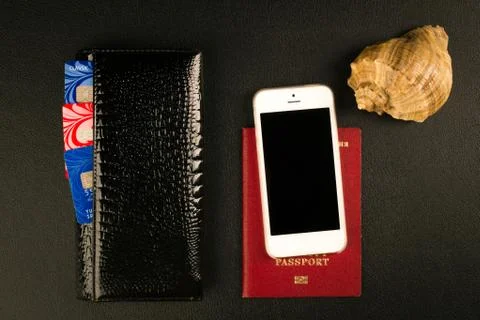 Passport, wallet and smartphone - travel concept, black background Stock Photos