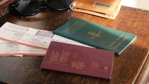 Passports dropped on the table next to flight tickets and sunglasses Stock-Footage 114825405