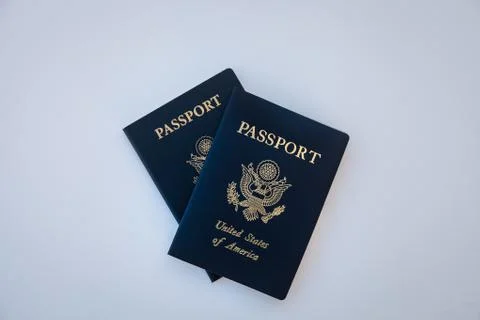Passports stacked on solid backdrop Stock Photos