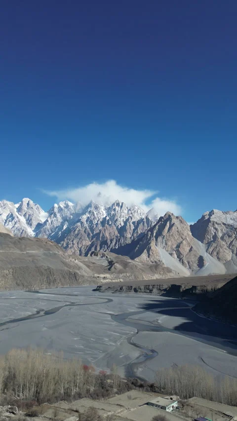 Passu cones and indus river flowing through rugged mountain Hunza Valley Stock Footage 245722086