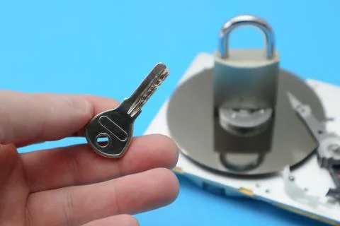 Password and data protection concept. A disassembled hard drive, pad lock and Stock Photos