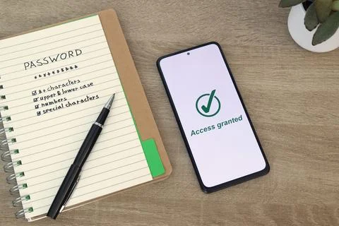 Password Security Checklist Notebook with Phone Showing Access Granted Stock Photos