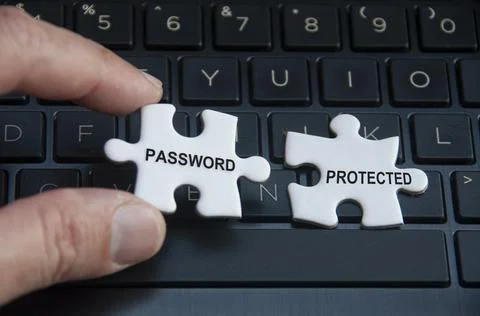 Password text on missing jigsaw puzzle with laptop and hand background. Stock Photos