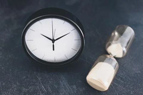 Past and present, clock and hourglass symbol of old and new lifestyles Stock Photos