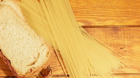 Pasta and bread on a wooden background Stock Footage 73408913